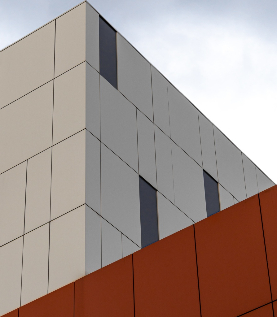 low-angle-view-modern-white-orange-building-bright-sky.jpg
